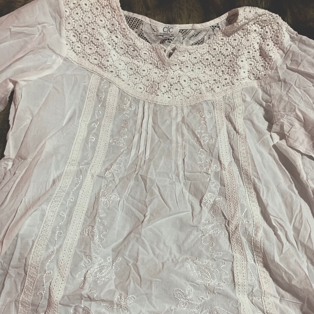 White long sleeve blouse with detailing.